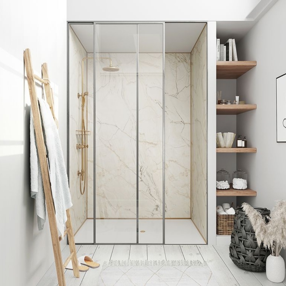 Lifestyle image of the Showerwall Laminate Shell Marble 2440mm x 879mm Proclick Hydrocore Wall Panel - SW64 installed in a bathroom with brushed brass fixtures and recessed walk-in shower